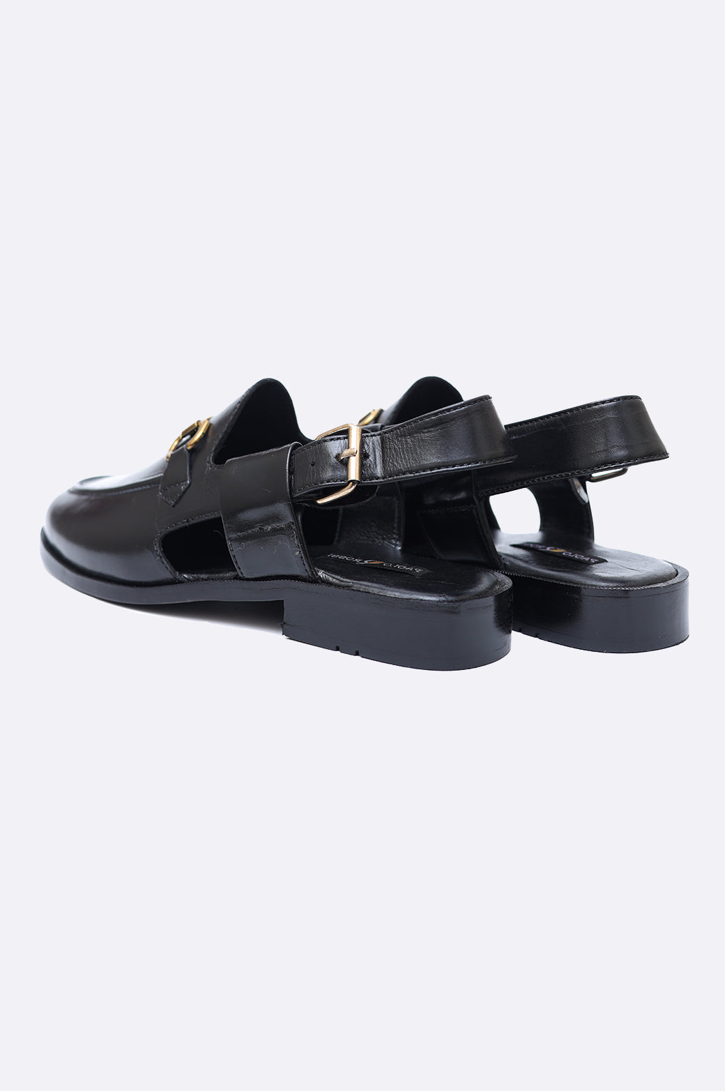 Pair of premium men's black leather closed-toe sandals with gold horsebit hardware and adjustable slingback heel straps.