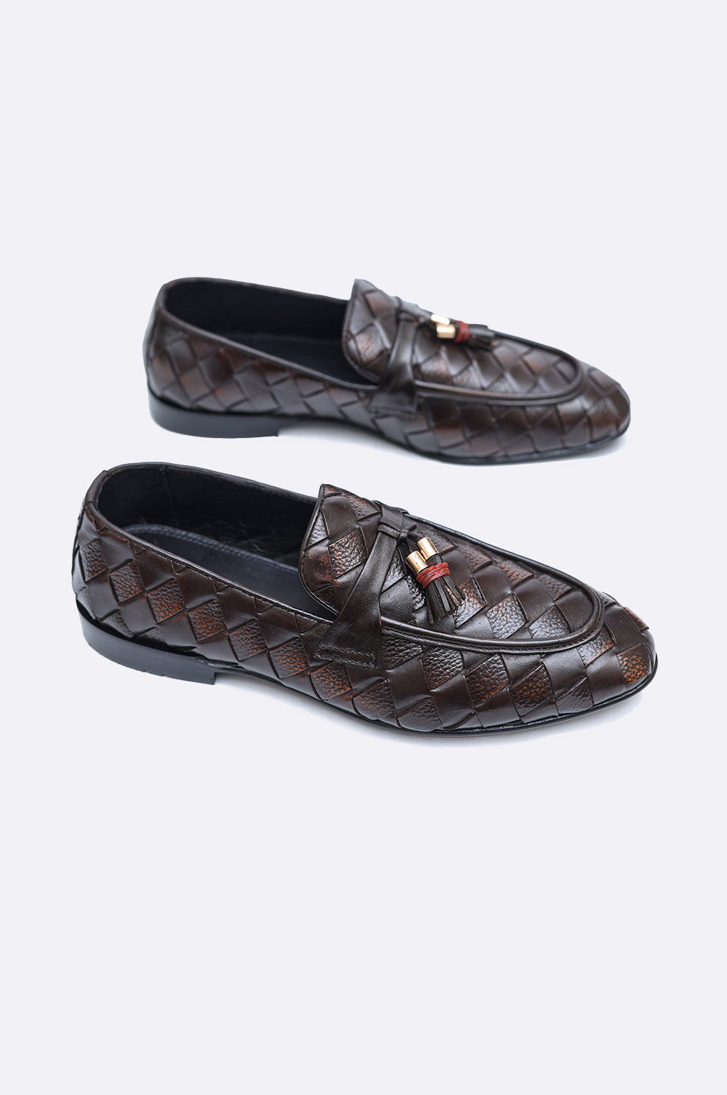 Pair of premium men's dark brown hand-woven leather loafers featuring twin tassels with gold-tone accents on a clean white background.